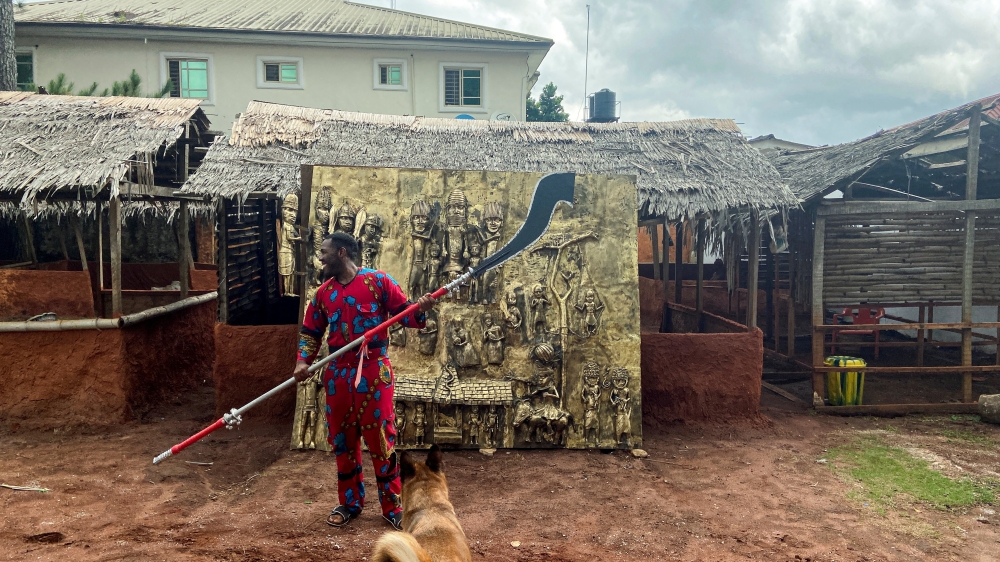 FILE PHOTO: Artist and bronze caster Osarobo Zeickner-Okoro is seen in front of a newly unveiled plaque that he is offering to the British Museum as a gift, in Benin City, Nigeria, July 31, 2021. Picture taken July 31, 2021. REUTERS/Tife Owolabi/File Phot