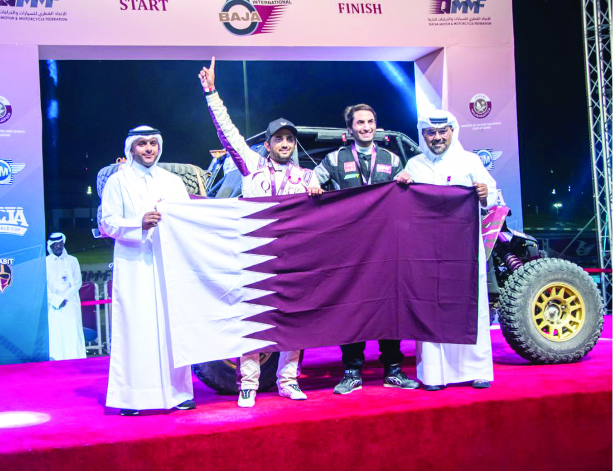 Qatar's Ahmed Al Kuwari and Nasser Al Kuwari celebrate their victory with Qatar Motor & Motorcycle Federation President Abdulrahman Al Mannai (right) and QMMF Executive Director Amro Al Hamad.