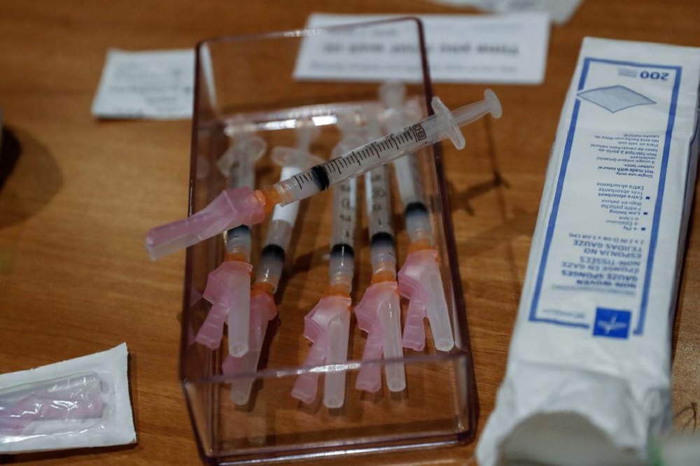 Syringes filled with a dose of the Moderna COVID-19 vaccine sit on a table during an employee vaccination at the Sarasota Memorial Hospital in Sarasota, Florida, U.S., September 24, 2021. REUTERS/Shannon Stapleton