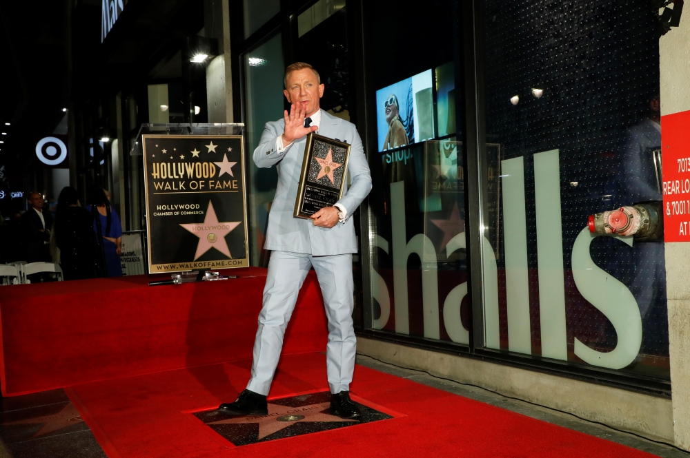 Actor Daniel Craig poses after unveiling his star on the Hollywood Walk of Fame in Los Angeles, California, U.S., October 6, 2021. REUTERS/Mario Anzuoni