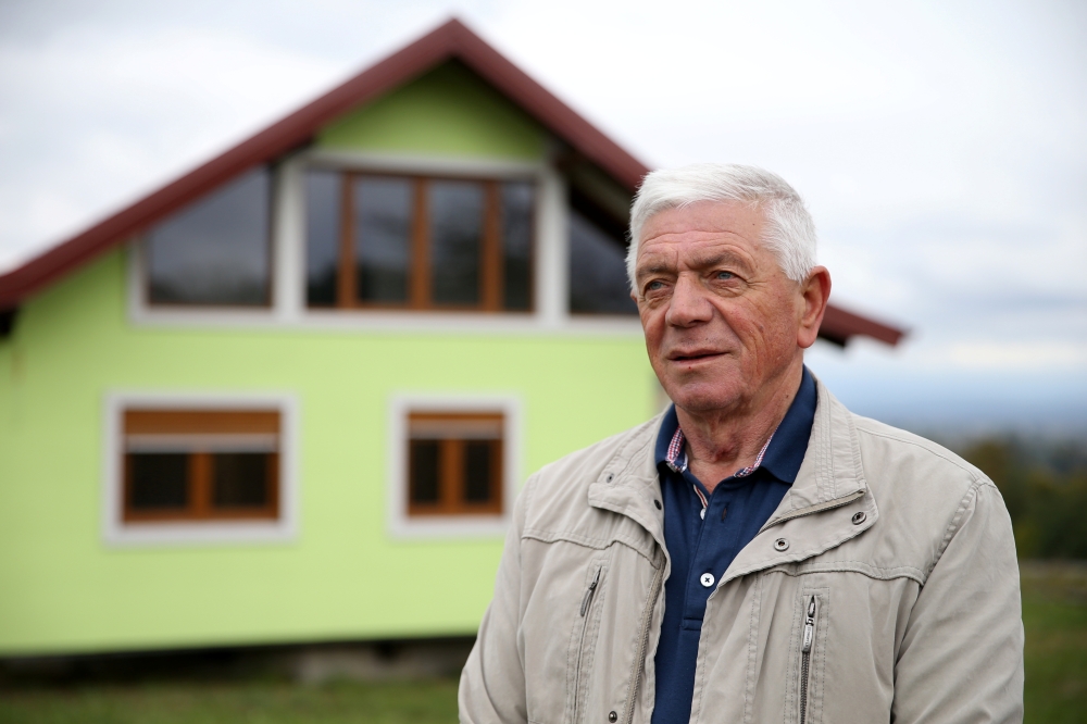 Vojin Kusic poses for a photo in front of his rotating house in Srbac, Bosnia and Herzegovina October 9, 2021. Reuters/Dado Ruvic