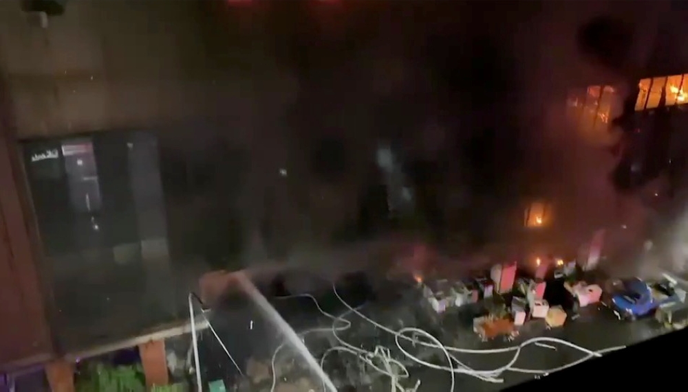 Jets of water are sprayed as a fire blazes at Cheng Chung Cheng building in Kaohsiung, Taiwan in this still frame obtained from social media video dated early October 14, 2021. CHANG YU CHEN /via REUTERS