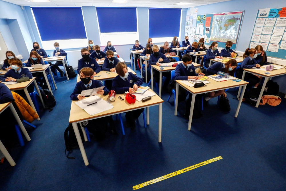 Students attend a lesson at Weaverham High School, as the coronavirus disease (Covid-19) lockdown begins to ease, in Cheshire, Britain, March 9, 2021. Reuters/Jason Cairnduff/File Photo