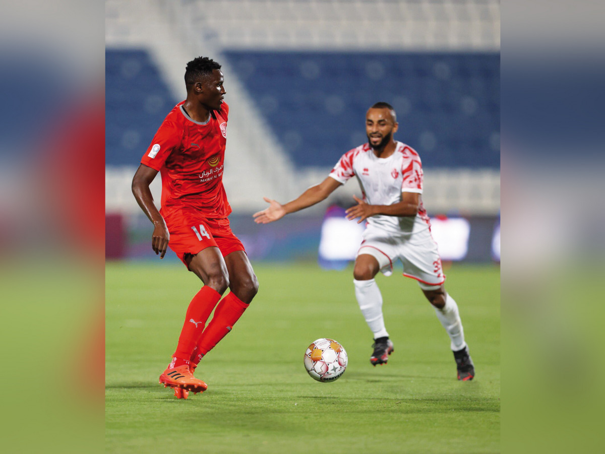 Al Duhail's Michael Olunga vies for the ball with an Al Shamal player.