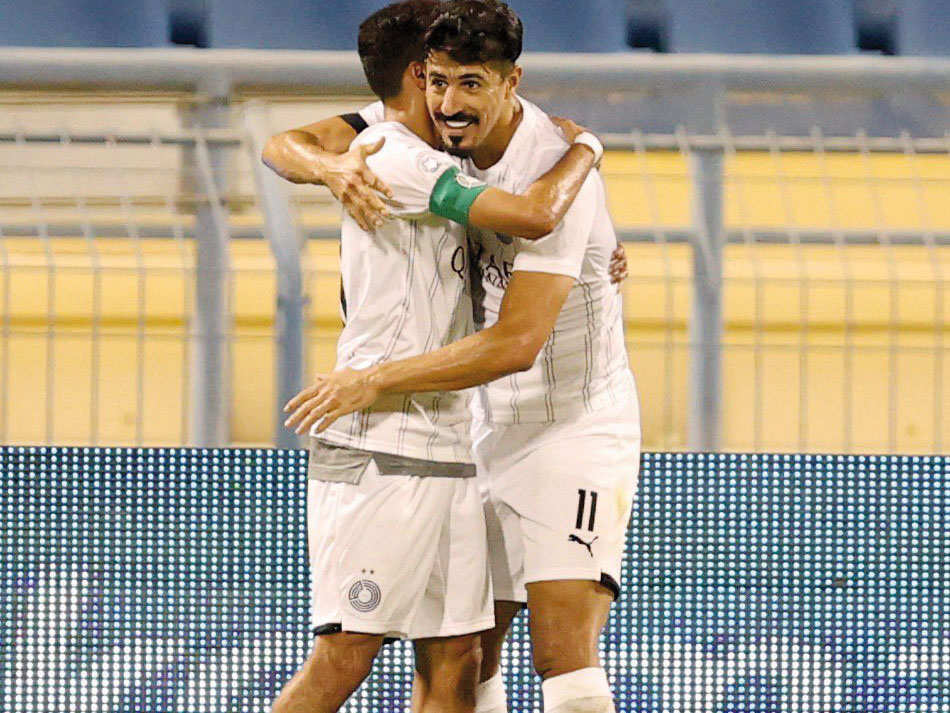 Al Sadd's captain Hassan Al Haydos congratulates Baghdad Bounedjah after the Algerian scored his second goal yesterday.