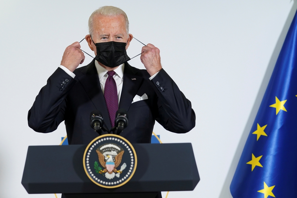 U.S. President Joe Biden adjusts his face mask as he and European Commission's President Ursula von der Leyen (not pictured) make a joint statement to speak about steel and aluminium tariffs, on the sidelines of the G20 leaders' summit in Rome, Italy October 31, 2021. REUTERS/Kevin Lamarque/File Photo