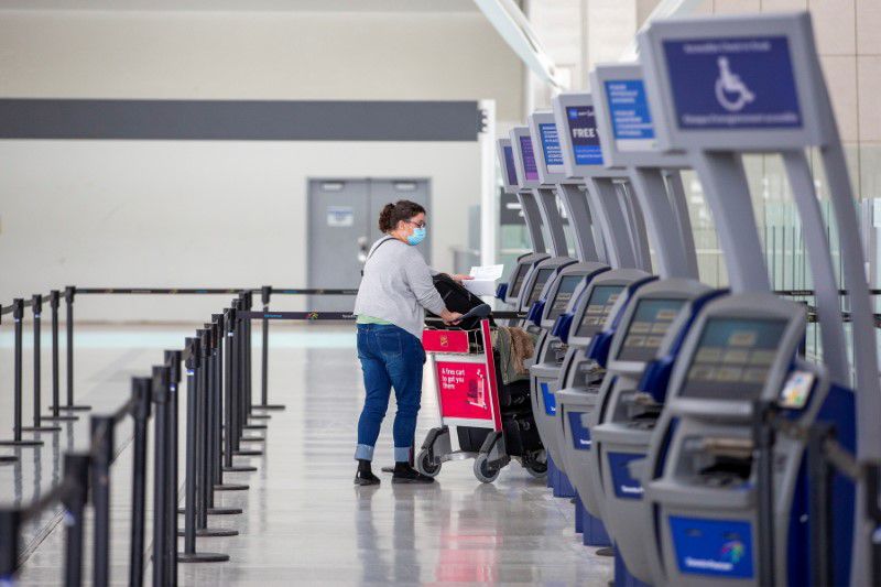 FILE PHOTO: A person wearing a protective mask walks through terminal 1 at Toronto's Pearson Airport after mandatory coronavirus disease (COVID-19) testing took effect for international arrivals in Mississauga, Ontario, Canada February 15, 2021. REUTERS/Carlos Osorio

