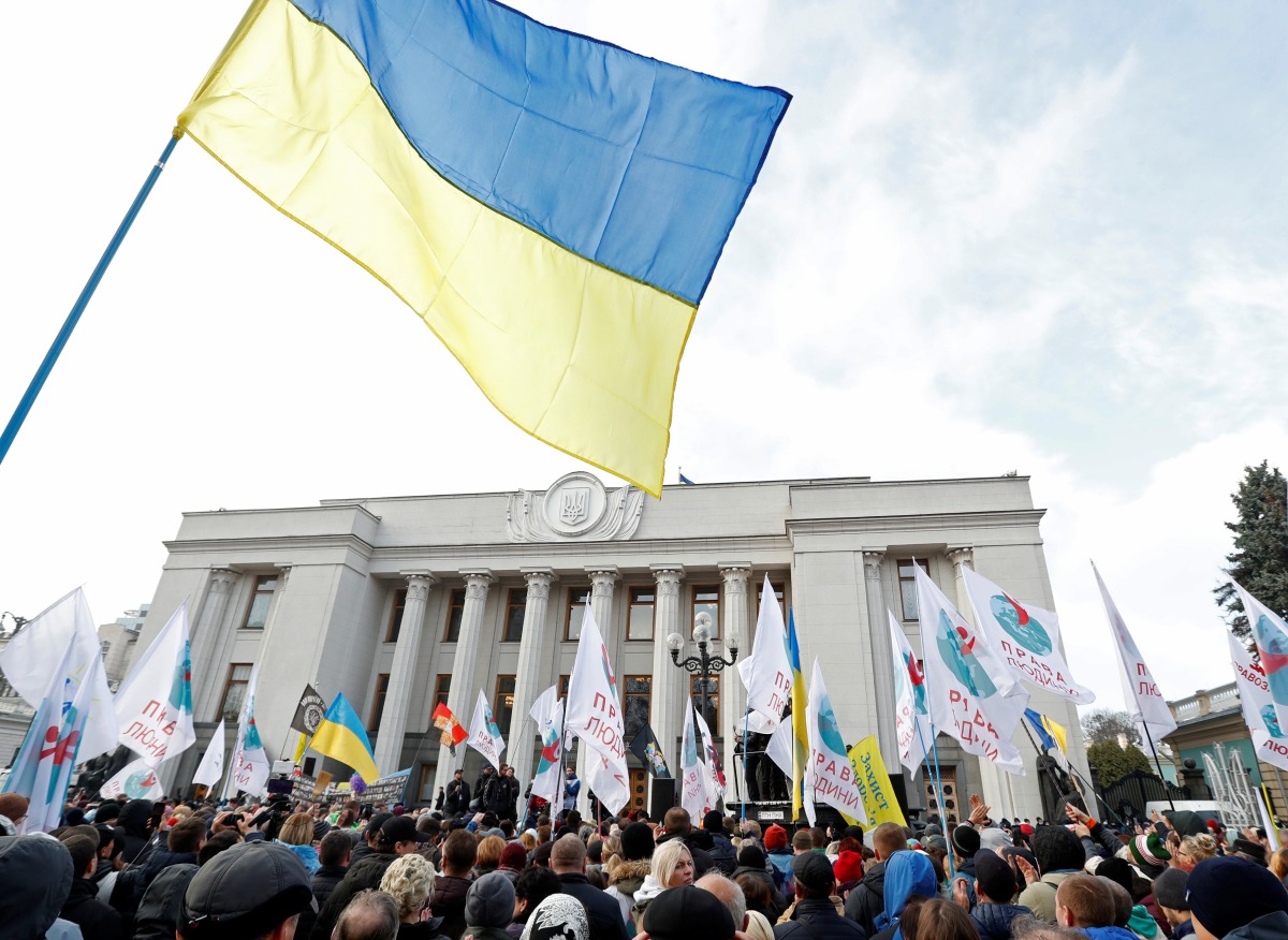 People attend a rally against the compulsory vaccination for some state employees and to demand the lifting of restrictions imposed by the authorities to curb the spread of the coronavirus disease (COVID-19) in Kyiv, Ukraine November 3, 2021. REUTERS/Valentyn Ogirenko

