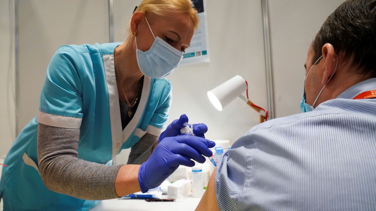 A man receives his first dose of the AstraZeneca coronavirus disease (COVID-19) vaccine at a mass vaccination centre in Riga, Latvia, April 16, 2021. REUTERS/Janis Laizans/File Photo

