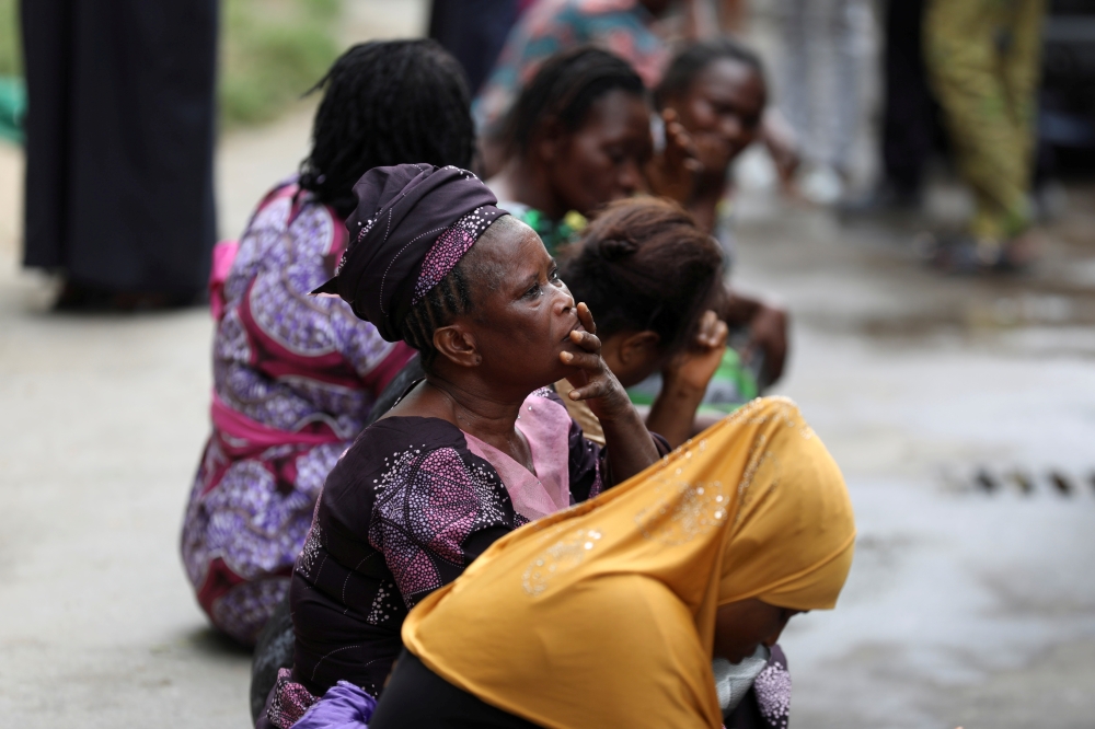 Relatives wait outside as rescue workers continue to conduct search and rescue effort at the site of a collapsed building in Ikoyi, Lagos, Nigeria November 2, 2021. REUTERS/Temilade Adelaja/File Photo