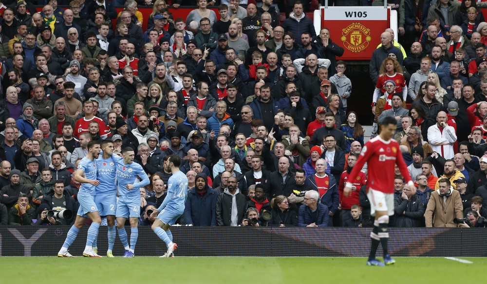 Manchester City's Ruben Dias, Joao Cancelo, Phil Foden and Bernardo Silva celebrate after Manchester United's Eric Bailly scores an own goal and Manchester City's first REUTERS/Craig Brough
