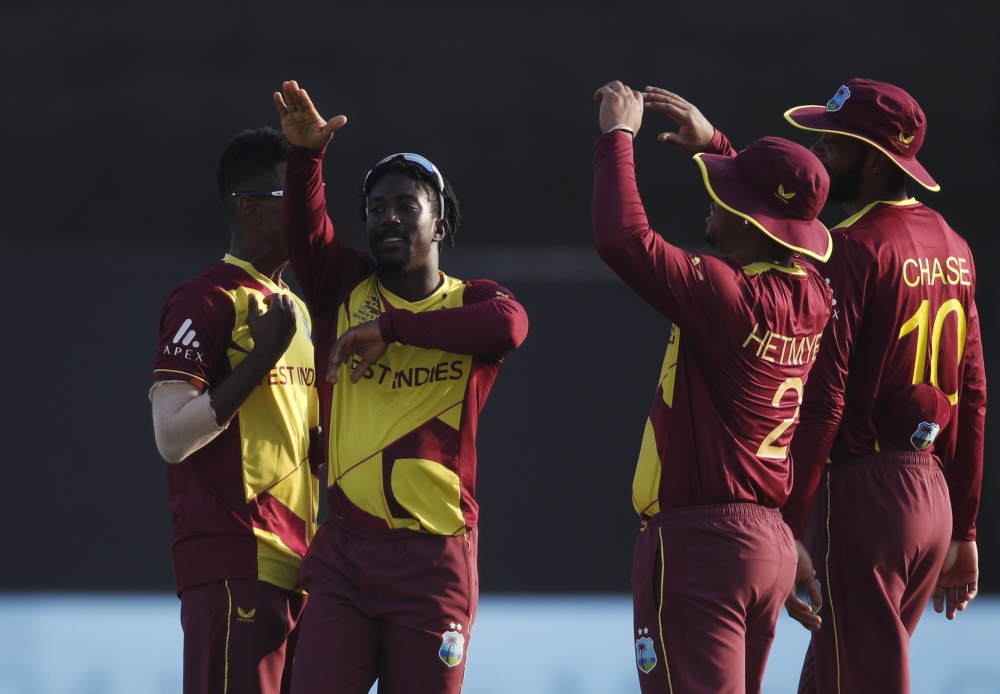 West Indies' Akeal Hosein celebrates taking the wicket of Australia's Aaron Finch with teammates Reuters/Hamad I Mohammed