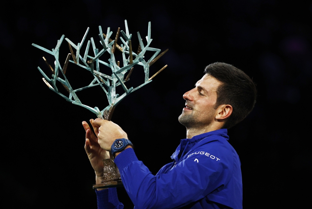 Serbia's Novak Djokovic holds the trophy and celebrates winning his final match against Russia's Daniil Medvedev REUTERS/Christian Hartmann

