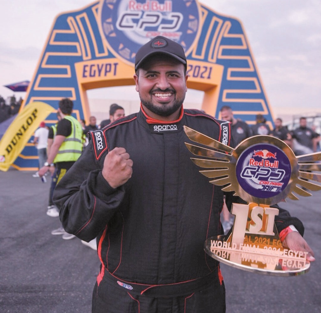 Qatar’s Ahmed Al Amri celebrates with the Red Bull Car Park Drift 2021 winner's trophy at the Al Manara Arena in Cairo, Egypt.