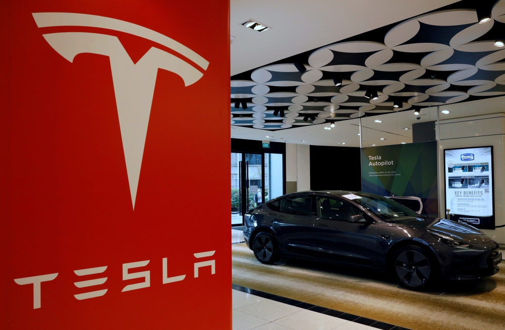 A Tesla model 3 car is seen in their showroom in Singapore October 22, 2021. Picture taken October 22, 2021. REUTERS/Edgar Su/File Photo