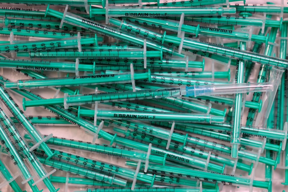 Empty syringes are pictured after a coronavirus disease (COVID-19) vaccination at a doctor's office in Berlin, Germany, November 2, 2021. REUTERS/Hannibal Hanschke/File Photo