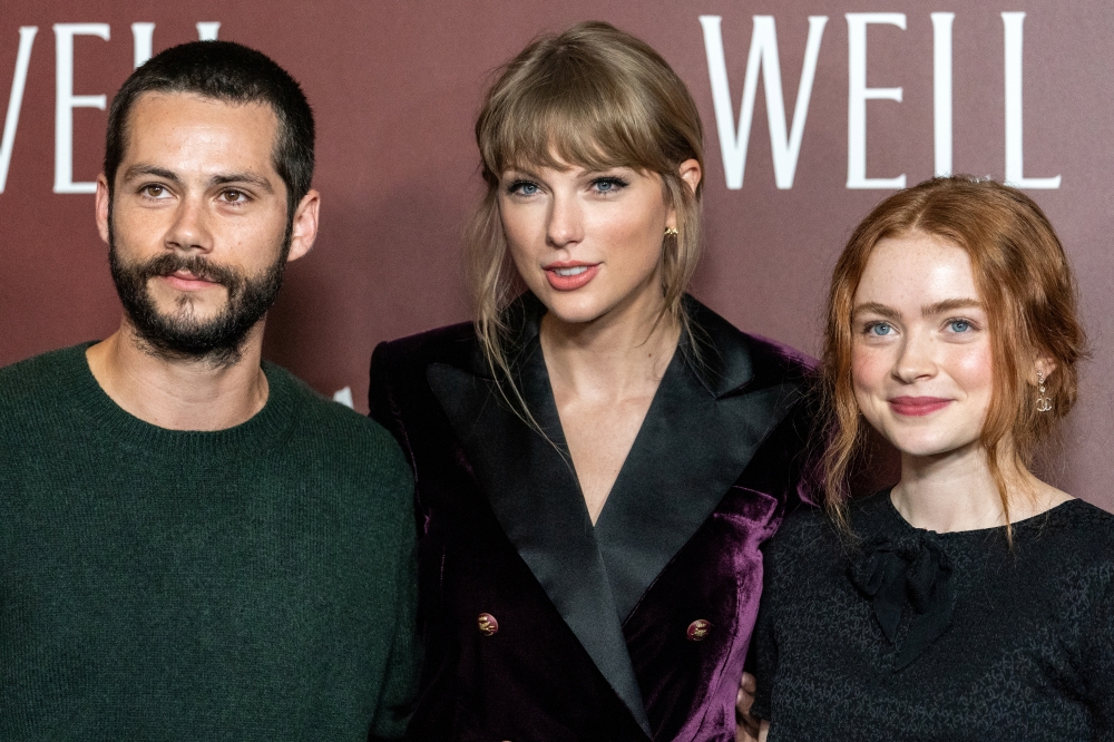 Dylan O'Brien, Taylor Swift and Sadie Sink pose during the 