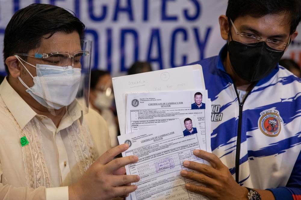 Representatives of Philippine President Rodrigo Duterte file his certificate of candidacy for senator after withdrawing his certificate of candidacy for vice president, in the 2022 national election, at the Commission on Elections, in Manila, Philippines, November 15, 2021. REUTERS/Eloisa Lopez