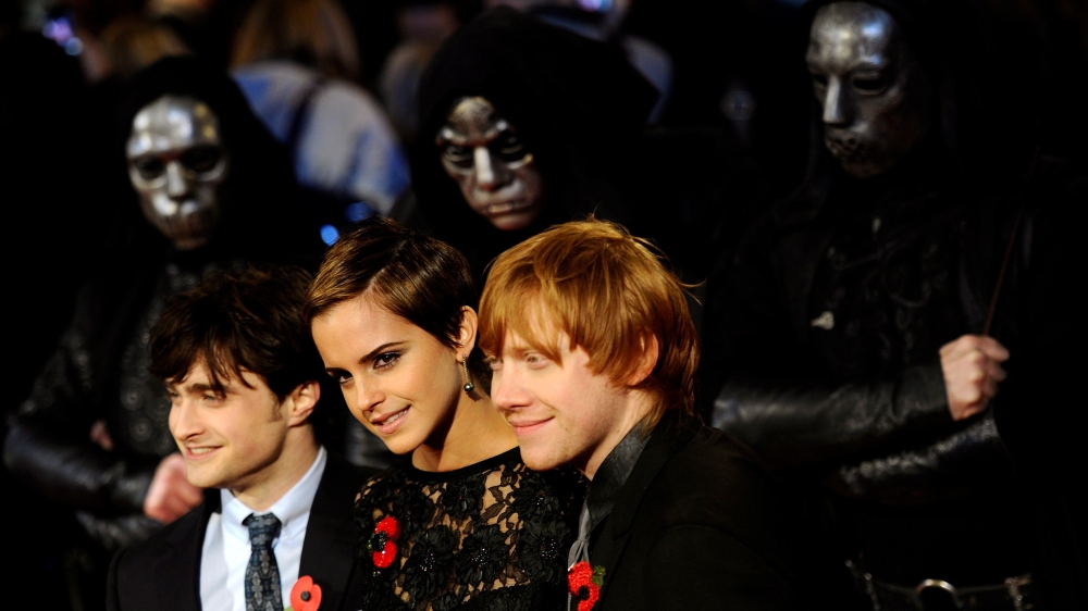 FILE PHOTO: Britain's Emma Watson poses with Daniel Radcliffe (L) and Rupert Grint pose as they arrive for the world premiere of 