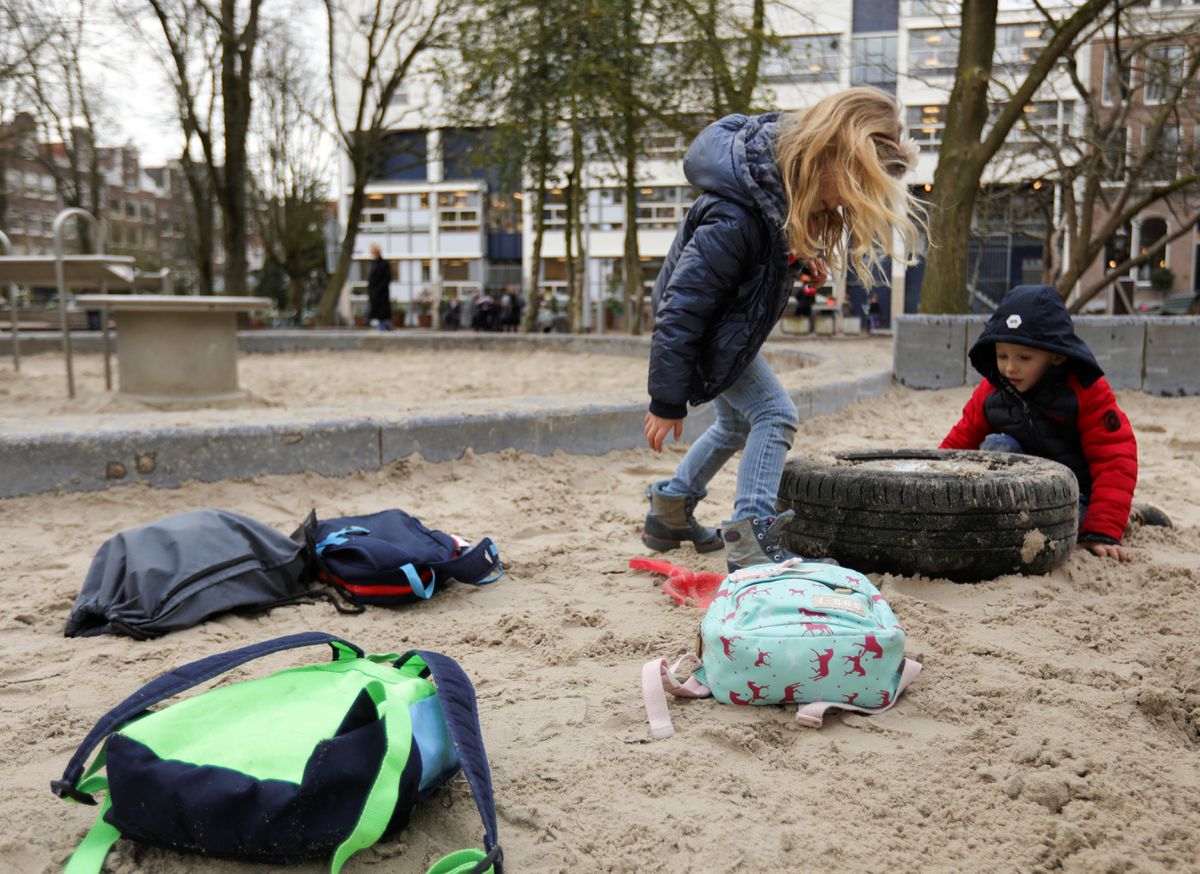Children are seen leaving school on a Friday after a nation-wide ban on large public gatherings to avoid coronavirus spreading in Amsterdam, Netherlands March 13, 2020. REUTERS/Eva Plevier

