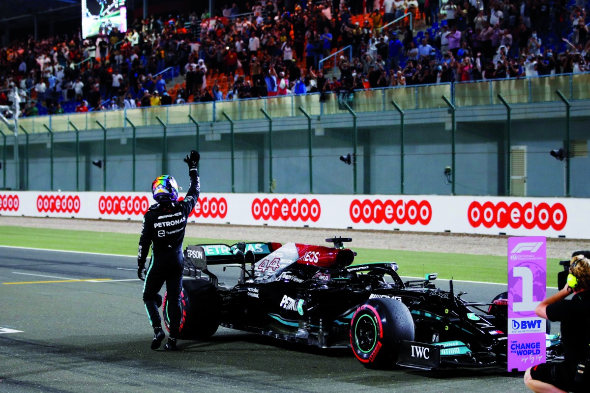 World champion Lewis Hamilton waves at the crowd after finishing in first place in the qualifying session