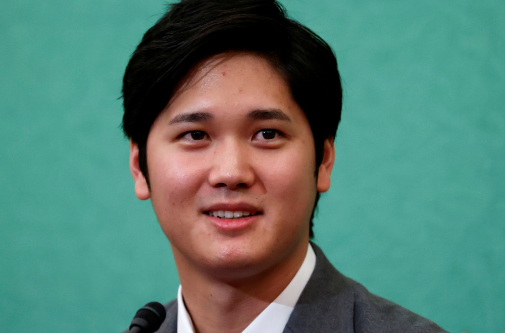 Japanese two-way baseball player for the Los Angeles Angels Shohei Ohtani attends a news conference at the Japan National Press Club in Tokyo, Japan November 15, 2021. REUTERS/Issei Kato/File Photo