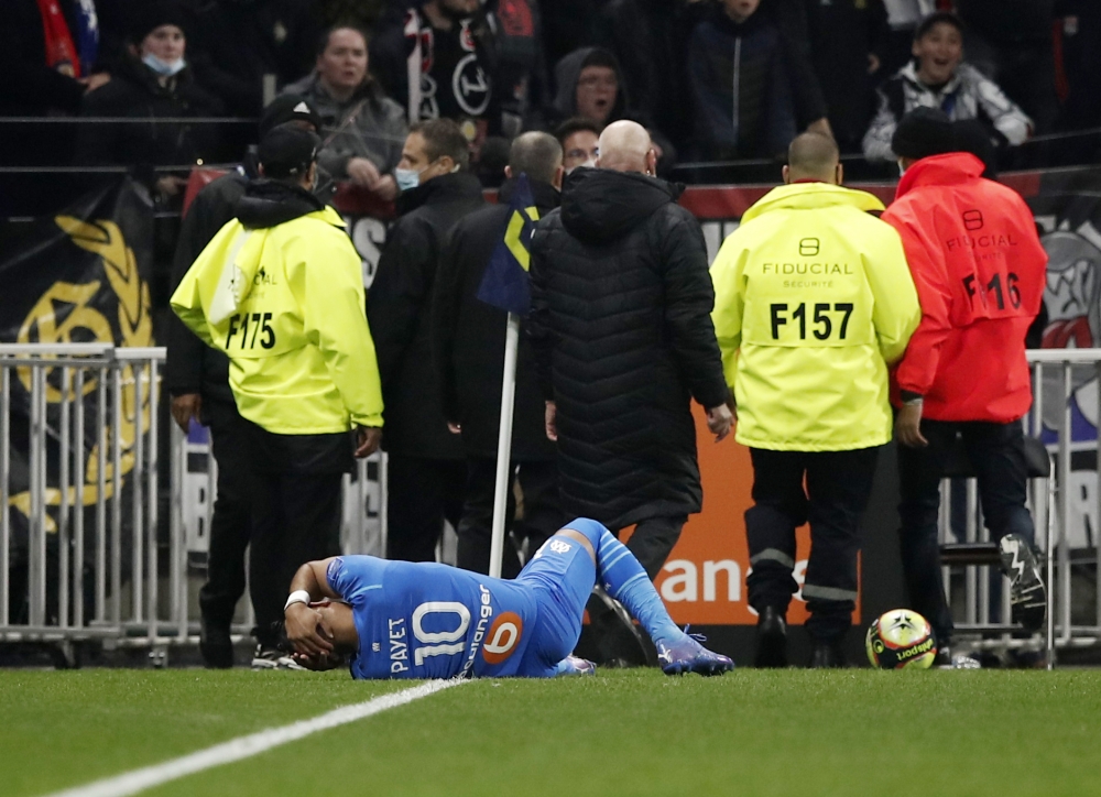 Olympique de Marseille's Dimitri Payet goes down after being hit by a water bottle thrown by a fan REUTERS/Benoit Tessier