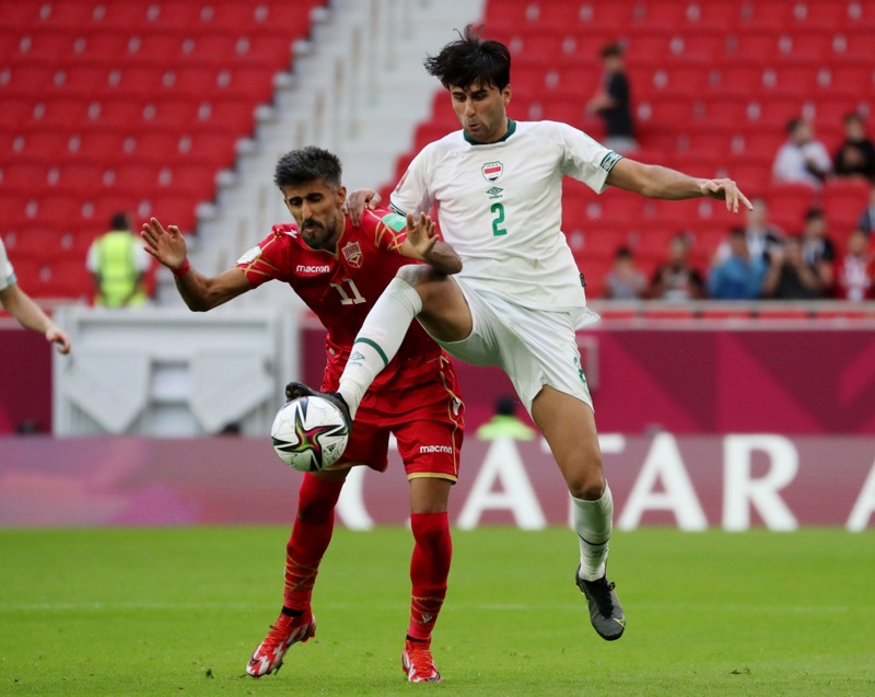 December 3, 2021 Bahrain's Ismaeel Abdullatif in action with Iraq's Manaf Younnes REUTERS/Suhaib Salem