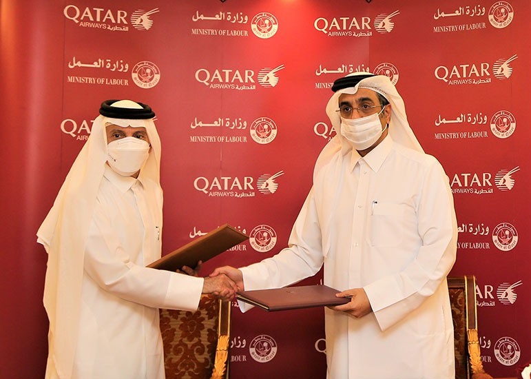 Minister of Labour H E Dr. Ali bin Smaikh Al Marri and Qatar Airways Group Chief Executive H E Akbar Al Baker exchanging documents after signing the agreement.