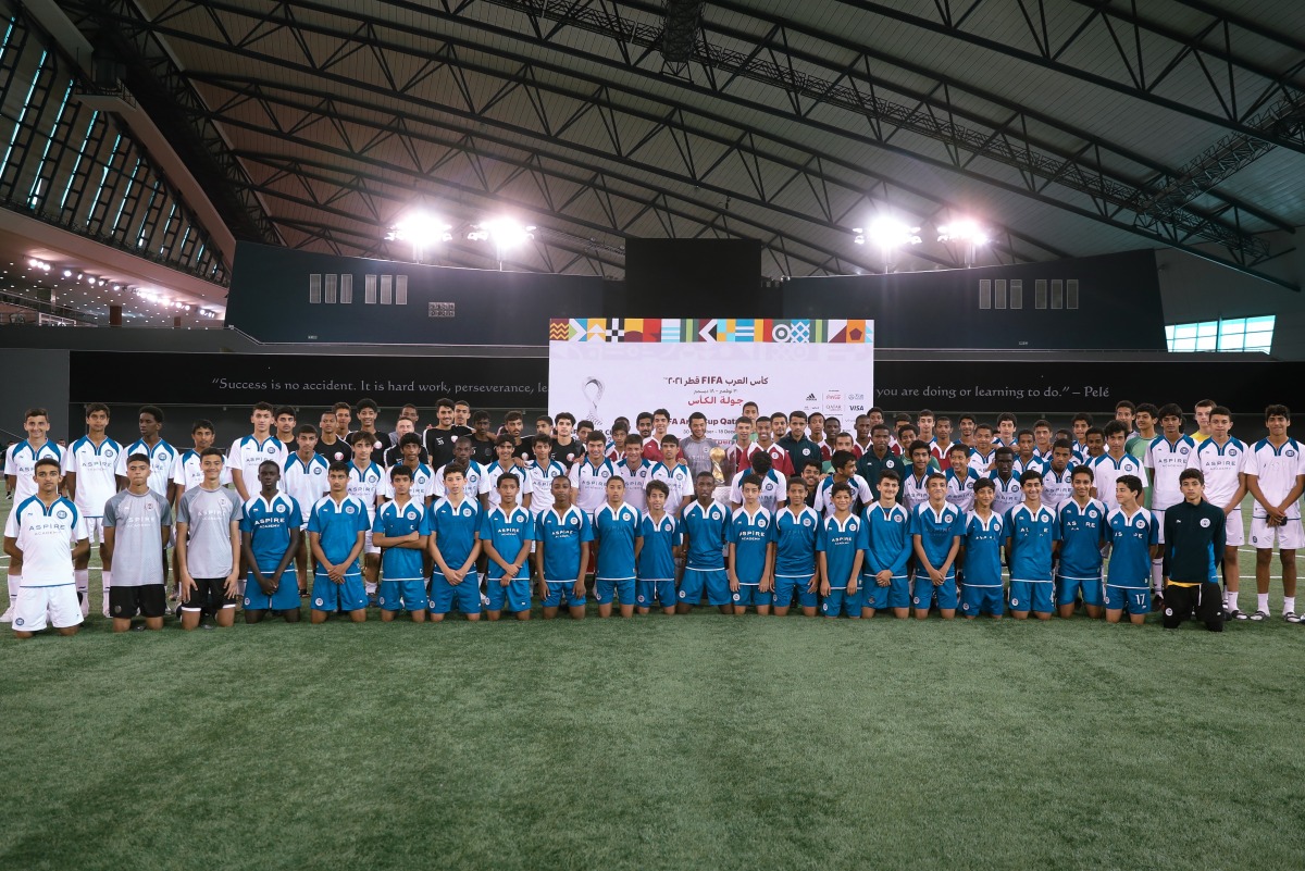 Aspire student athletes with the FIFA Arab Cup 2021 Trophy. 