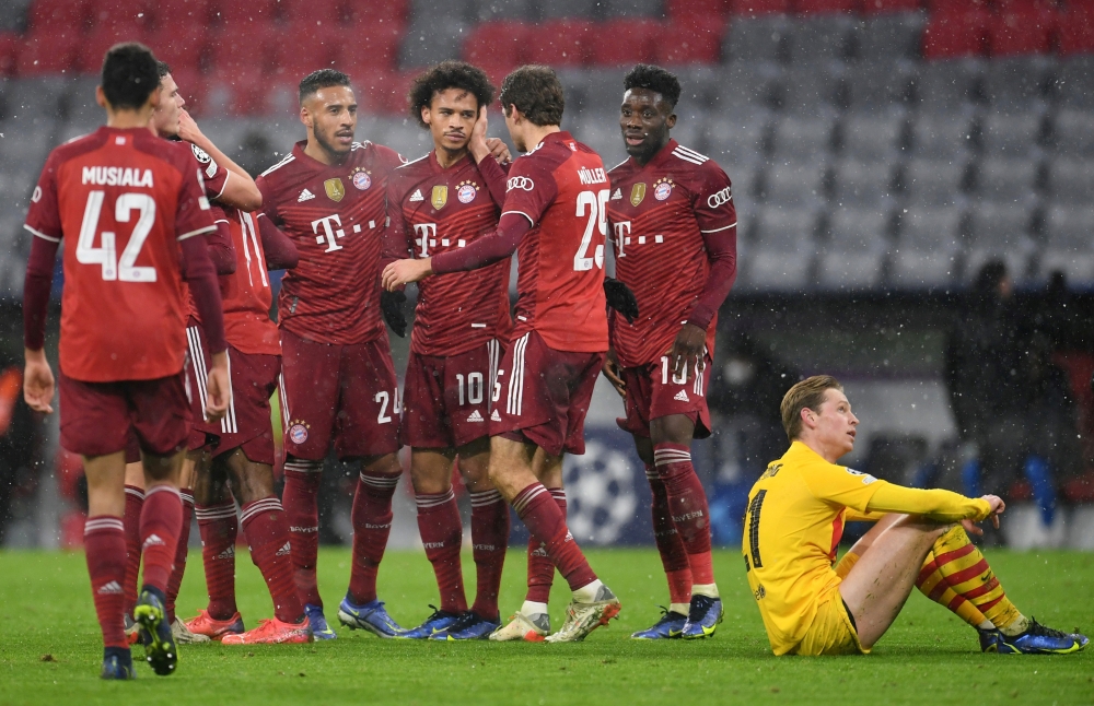 Bayern Munich's Leroy Sane celebrates scoring their second goal with teammates REUTERS/Andreas Gebert
