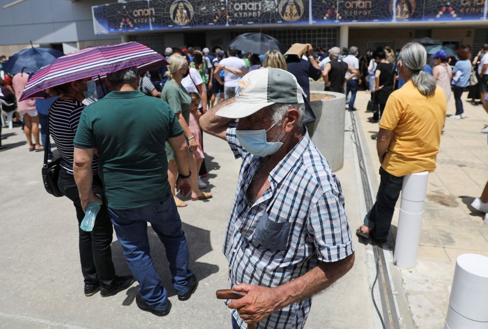 People wait outside a vaccination centre, amid the coronavirus disease (COVID-19) pandemic in Limassol, Cyprus May 4, 2021. REUTERS/Yiannis Kourtoglou
