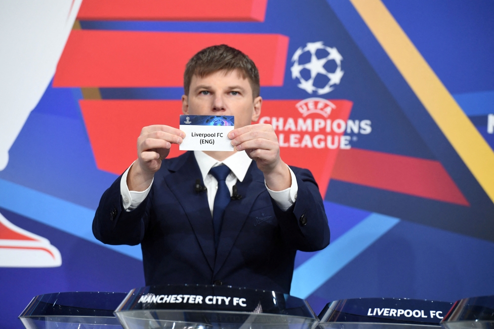 Andrey Arshavin draws out the card of Liverpool during the UEFA Champions League 2021/22 Round of 16 Draw at the UEFA headquarters UEFA/Handout via REUTERS 