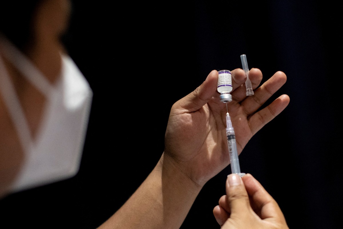 FILE PHOTO: A healthworker prepares a dose of COVID-19 vaccine for protection against the coronavirus disease at a cinema turned into a temporary vaccination site in San Juan, Metro Manila, Philippines, December 15, 2021. REUTERS/Eloisa Lopez/File Photo
