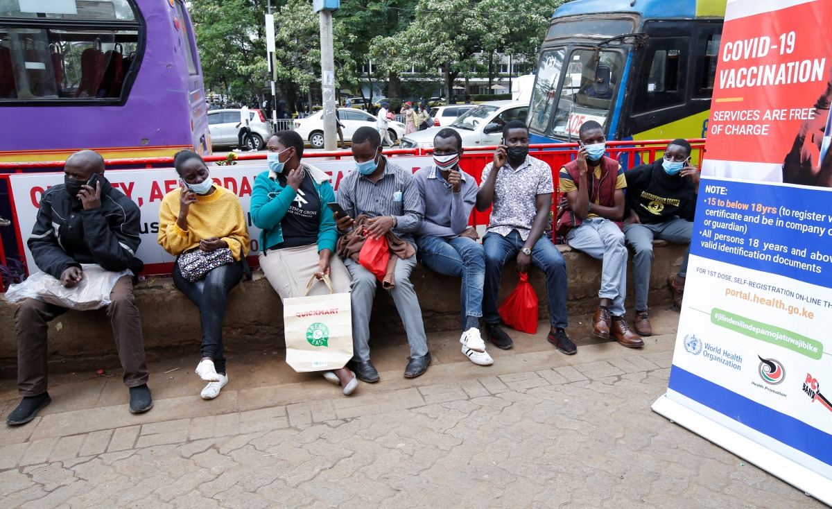 Civilians queue to receive the coronavirus disease (COVID-19) vaccine at a makeshift tent as the government orders for proof of vaccination to access public places and transport, in downtown Nairobi, Kenya December 23, 2021. REUTERS/Monicah Mwangi

