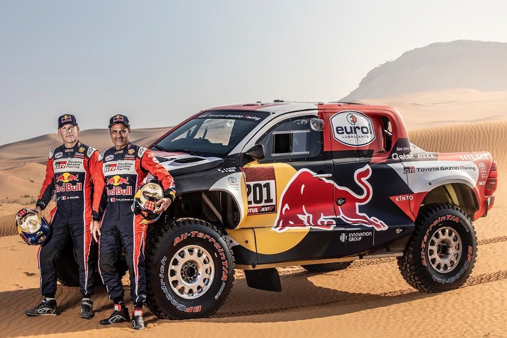 Qatar's Nasser Al Attiyah and his French co-driver Matheiu Baumel pose for a photograph in front of their Toyota GR DKR Hilux T1+ ahead of the 2021 Dakar Rally.