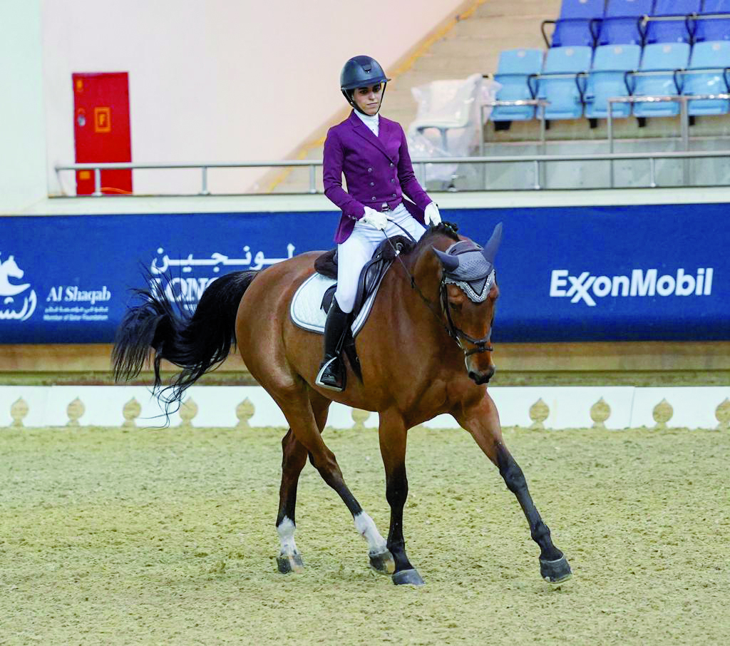 Maryam Ahmad Al Boinin astride Vol De Nuit Tardonne during the Dressage, Preliminary (Level 2) - Test 2C event in the third round of the Longines Hathab Qatar Equestrian Tour at Qatar Equestrian Federation's (QEF) Indoor Arena, yesterday. 