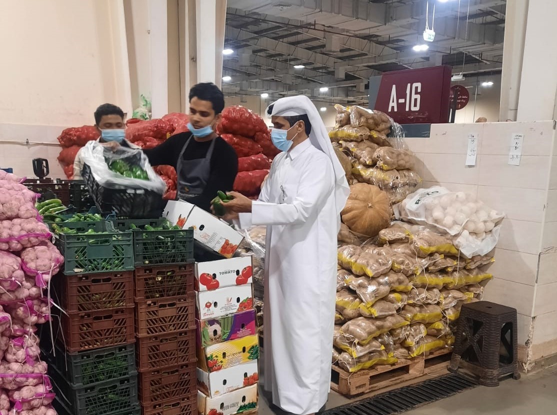 An inspector during a visit to a vegetable market.