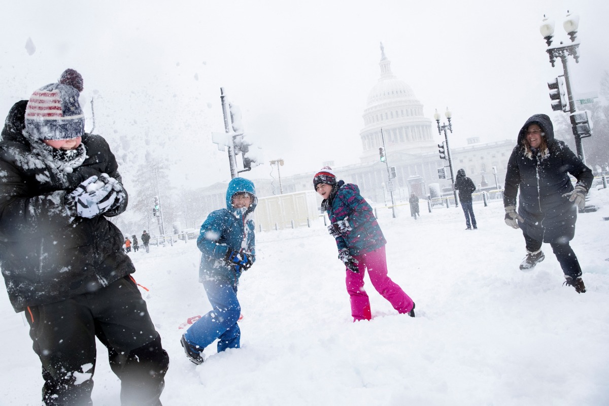 Will Modi, left, reacts after being hit by a snowball by Nicole D'ercole , right, during a snow storm on Capitol Hill in Washington, U.S., January 3, 2022. REUTERS/Tom Brenner
