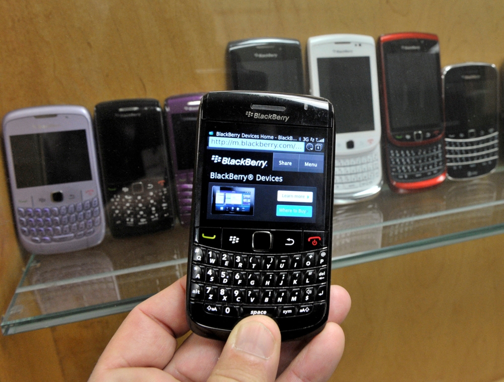A BlackBerry device is shown in front of products displayed in a glass cabinet at the Research in Motion offices in Waterloo November 14, 2012. REUTERS/Mike Cassese/File Photo