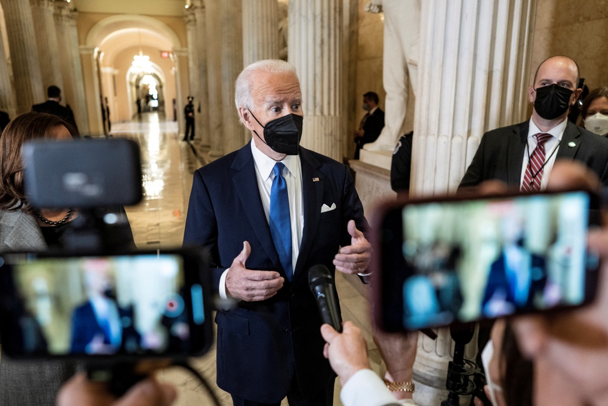 U.S. President Joe Biden speaks to reporters in the Hall of Columns on the one-year anniversary of the January 6, 2021 attack on the Capitol in Washington, U.S., January 6, 2022. Ken Cedeno/Pool via REUTERS
