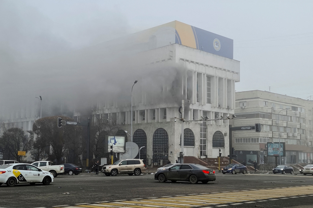 A view shows smoke billowing from inside a building that houses several TV and radio stations following the protests triggered by fuel price increase, in Almaty, Kazakhstan January 6, 2022. Picture taken January 6, 2022. REUTERS