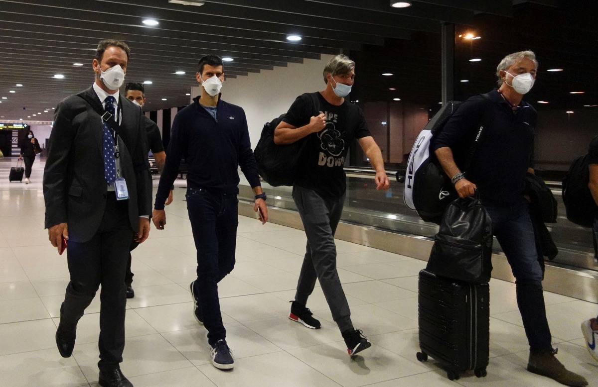 Serbian tennis player Novak Djokovic walks in Melbourne Airport before boarding a flight, after the Federal Court upheld a government decision to cancel his visa to play in the Australian Open, in Melbourne, Australia, January 16, 2022. REUTERS/Loren Elliott
