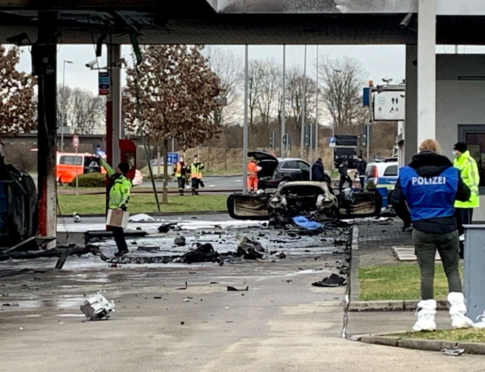 Police and specialists investigate the scene were two people were killed after a fire broke out in the pump area at a petrol station in Hammersbach, north-east of Frankfurt, Germany, January 17, 2022. REUTERS/Stringer 
