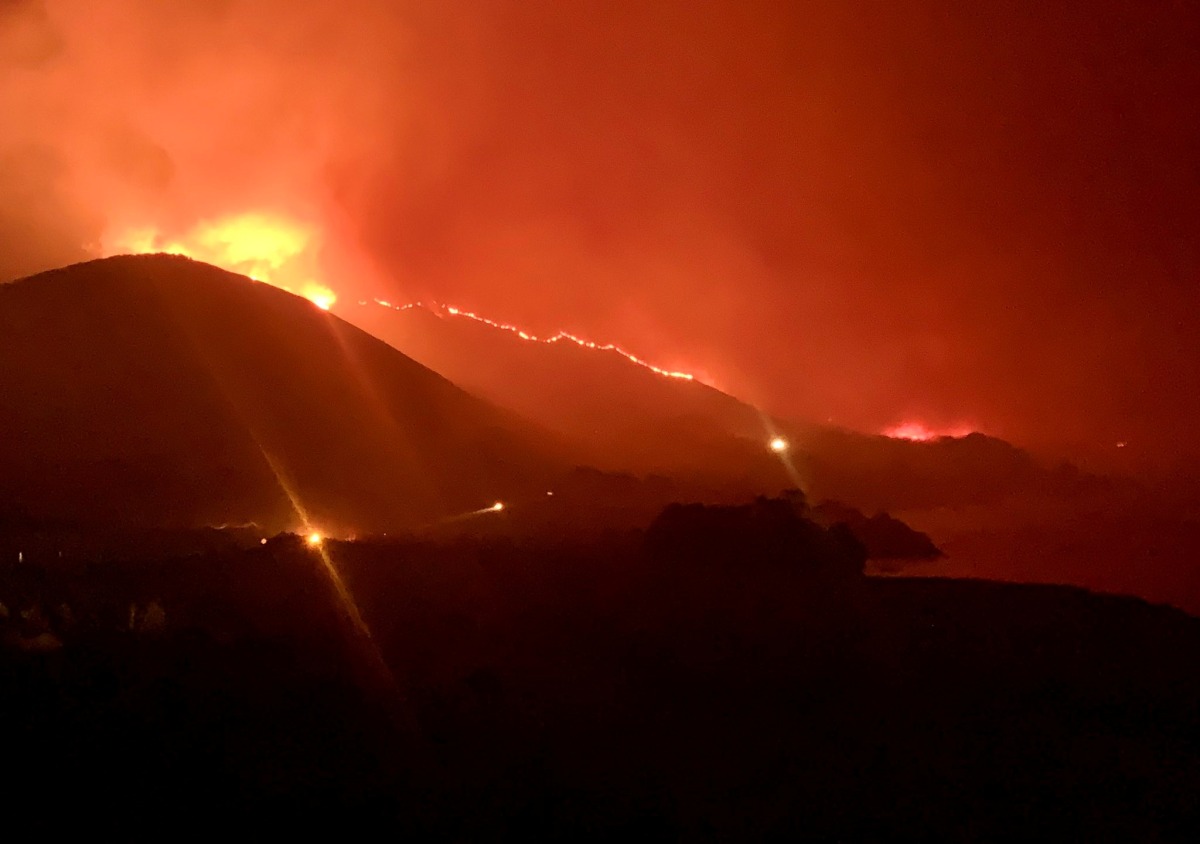 Wildfire burns in Rocky Point, Monterey County, California, U.S., in this handout photo taken over the night of January 21st or 22nd, 2022. DEBI LORENC/Handout via REUTERS