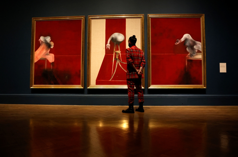 A staff member from the Royal Academy of Arts poses with 