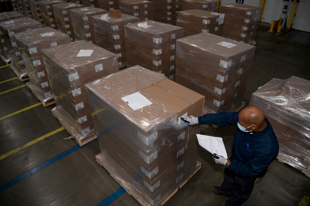 FILE PHOTO: A Pfizer employee checks the boxes containing Paxlovid, COVID-19 treatment pills, at a distribution facility in Memphis, Tennessee, U.S.
