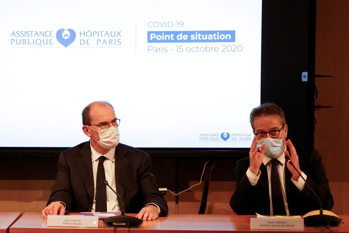 FILE PHOTO: French Prime Minister Jean Castex listens to Martin Hirsch, the Director General of Assistance Publique-Hopitaux de Paris (AP-HP), during a AP-HP meeting in Paris, France October 15, 2020. Ludovic Marin/Pool via REUTERS/File Photo
