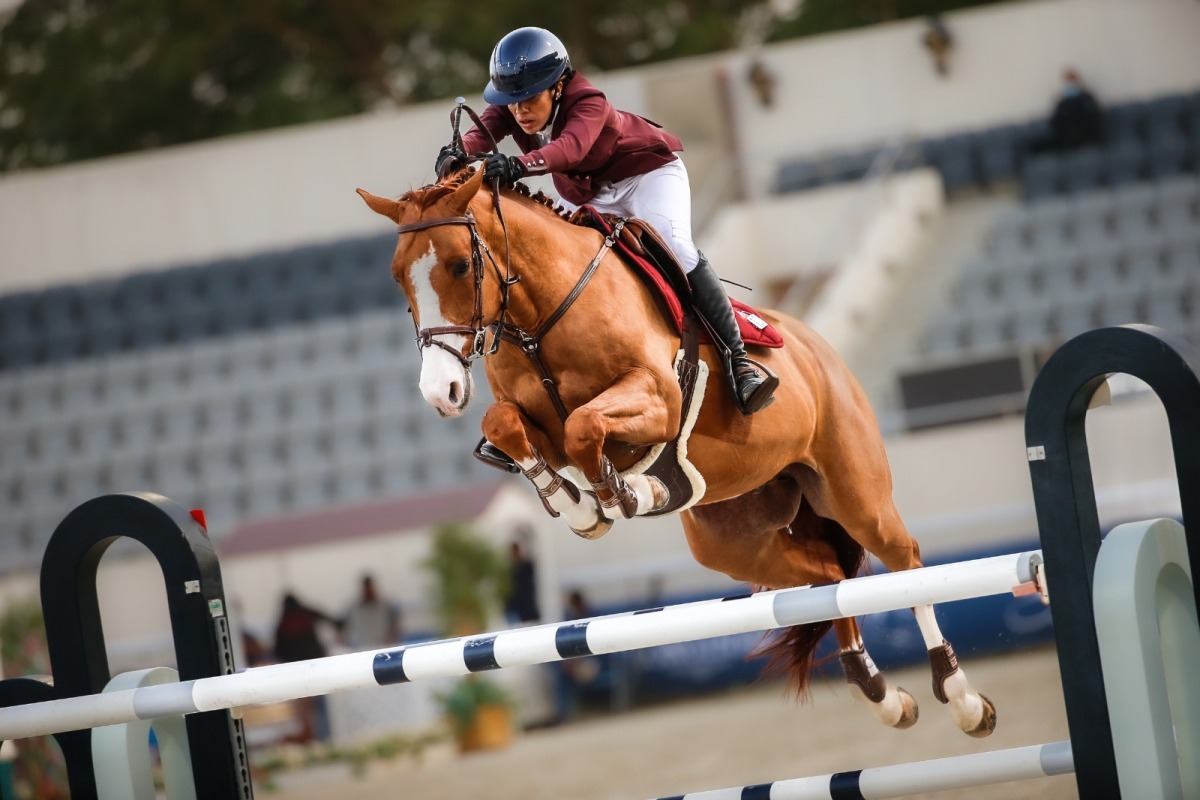 Cyrine Cherif guides her 11-year-old stallion Brennus Villelongue over a fence during ninth round of the Longines Hathab Qatar Equestrian Tour at the Qatar Equestrian Federation’s outdoor arena yesterday.