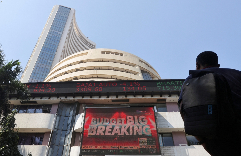 A man looks at a screen displaying budget news, on a facade of the Bombay Stock Exchange (BSE) building in Mumbai, India, February 1, 2022. Reuters/Francis Mascarenhas